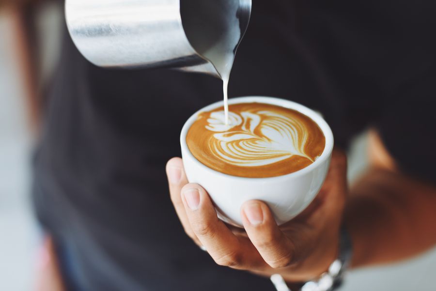 Cup of coffee on a wooden cafe table