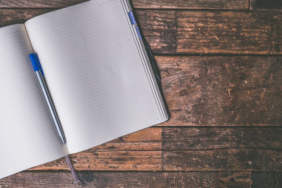 Open notebook with pen on a desk
